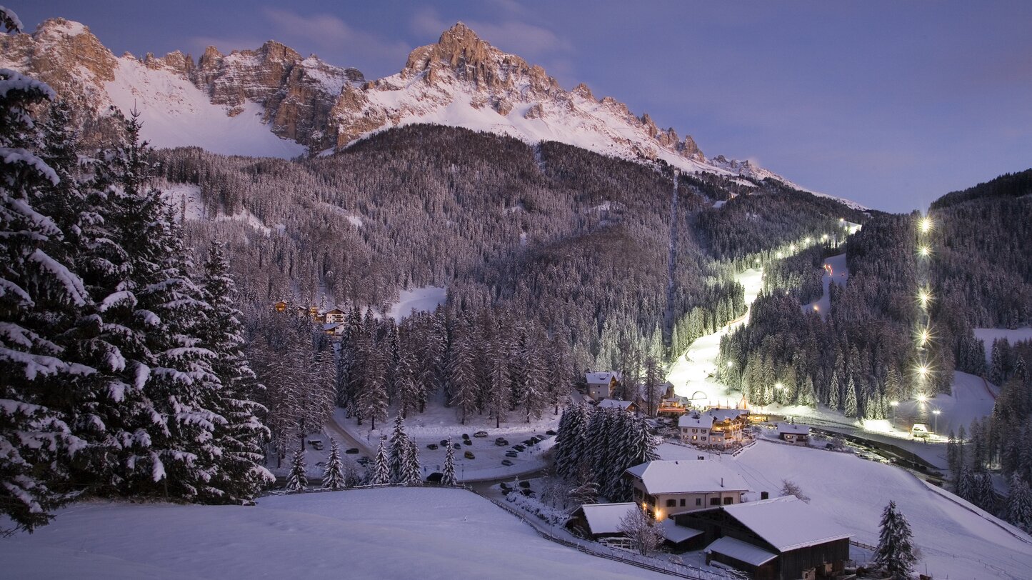 Obereggen Val d’Ega ski resort in South Tyrol, Italy - panoramic view of ski slopes and mountain facilities